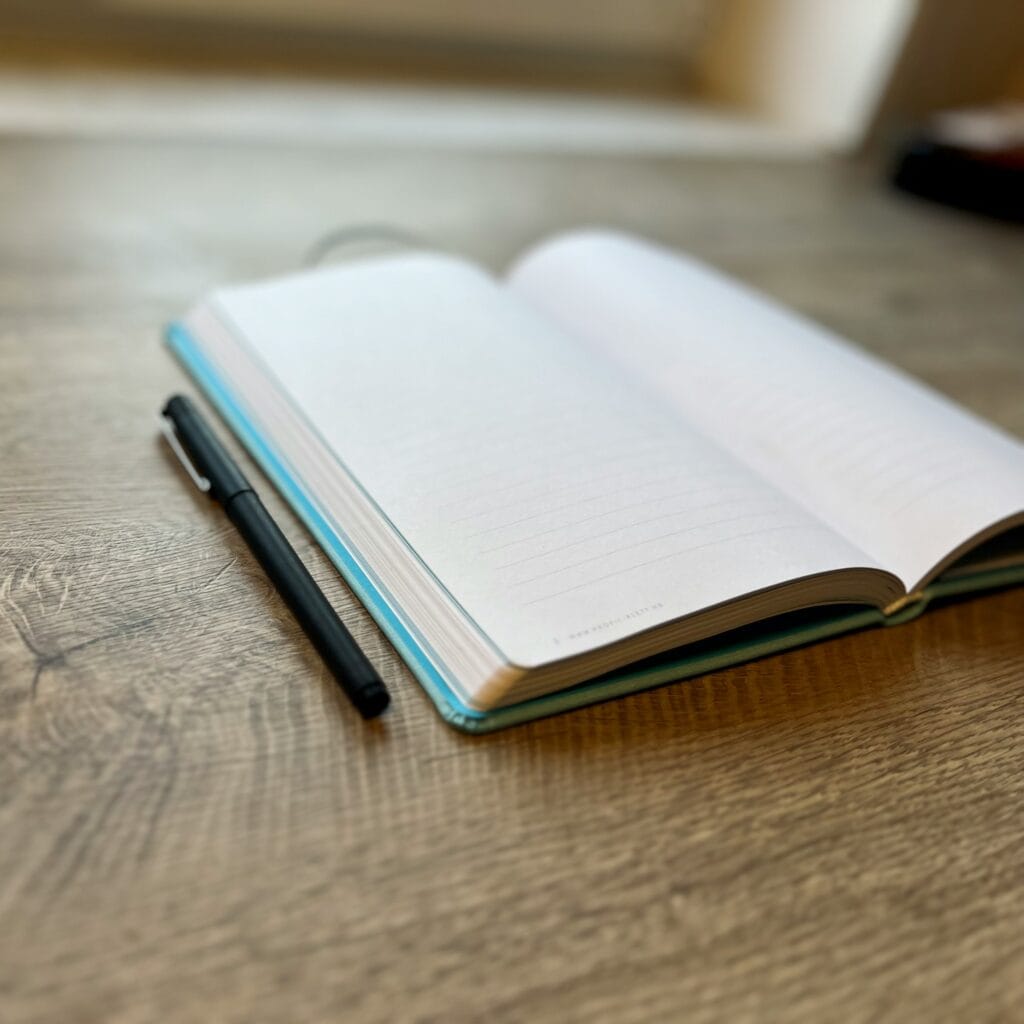 Notebook and pen for IGCSE English tutoring article